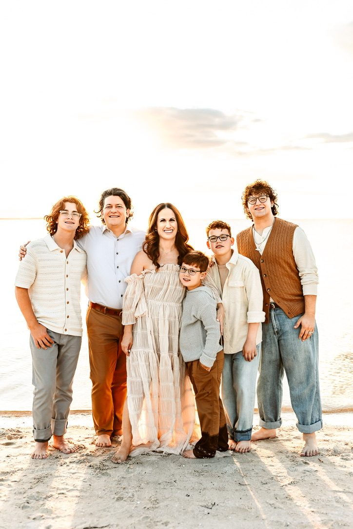 The Leggett family together on the beach at sunset